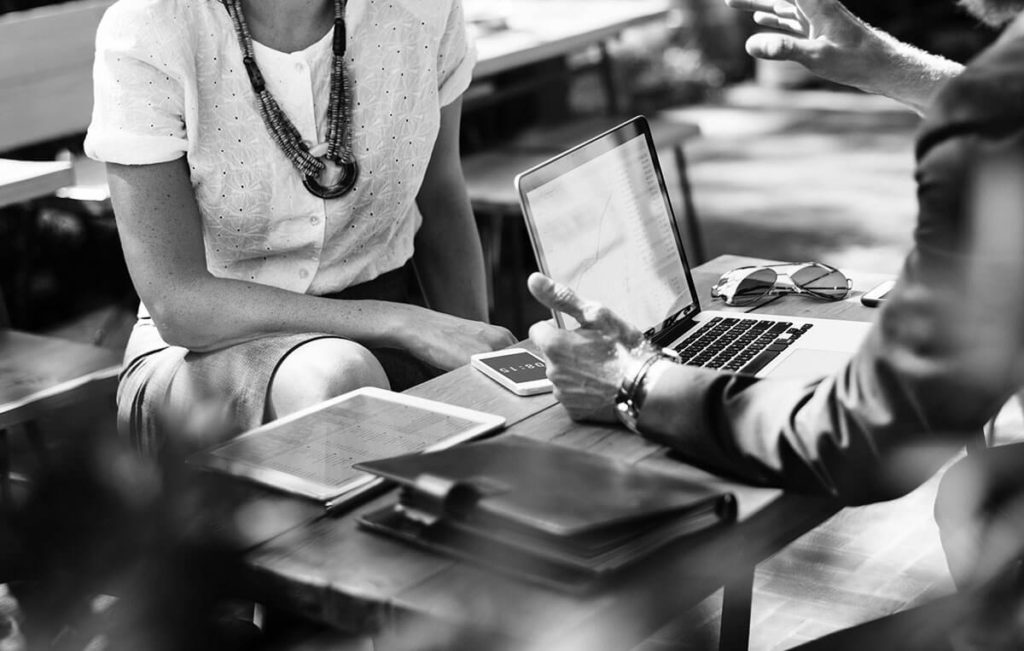 employees talking at a desk